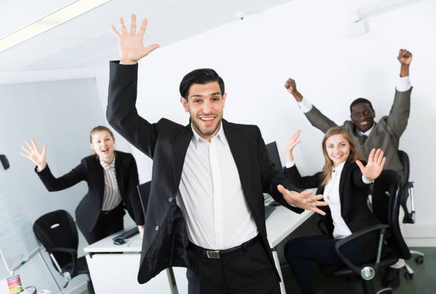 istock Cheerful businessman with happy team at office 1124361797