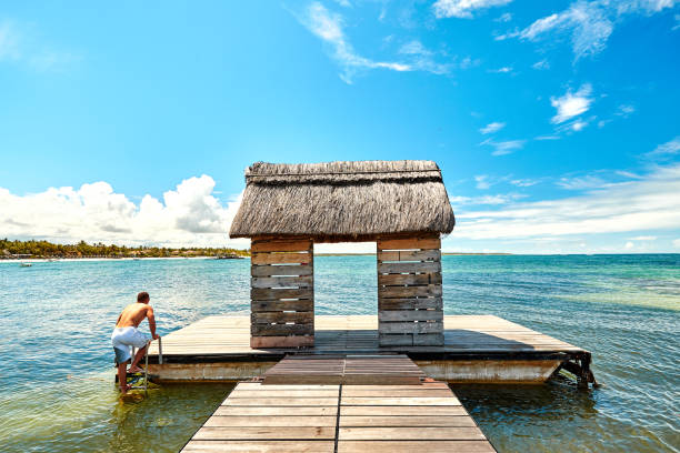 istock Jetty with man silhouette on pontoon in Mauritius Island 1124364184