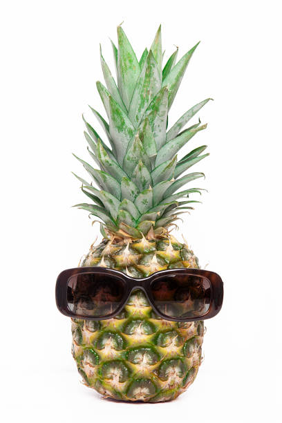 istock Ripe pineapple with sunglasses on a white background 1124365359