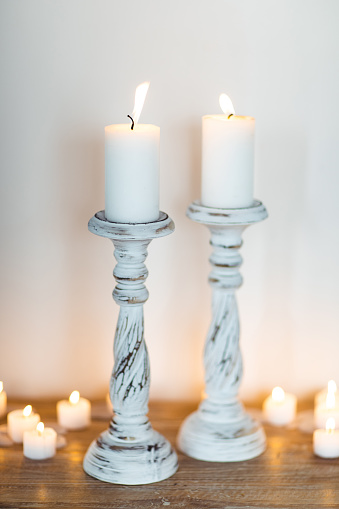 White wooden Candlestick with Candles. Place for Text. Hygge