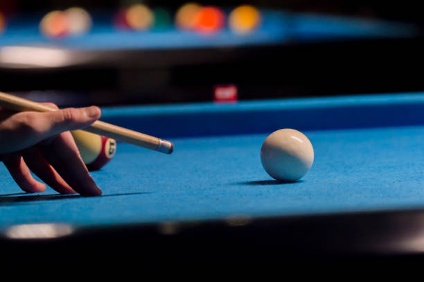 istock Playing billiard. Billiards balls and cue on blue billiards table 1124368298
