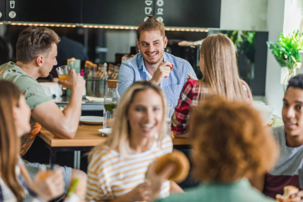istock University students talking on a lunch break in cafeteria. 1124368377