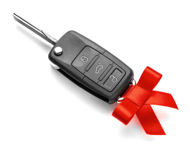 istock Gift Car keys with remote control alarm with red ribbon with bow. Isolated on white background. 1124371234