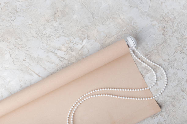 istock The roller blind lies on a white or gray concrete surface. 1124374076