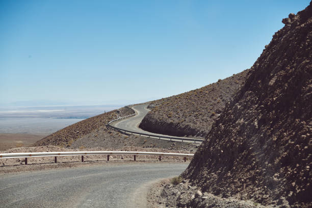 istock Road By Mountain Against Clear Blue Sky 1124374758