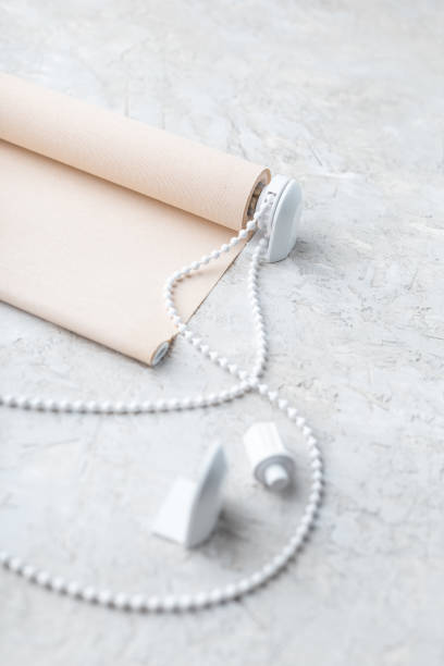 istock The roller blind lies on a white or gray concrete surface. 1124375149
