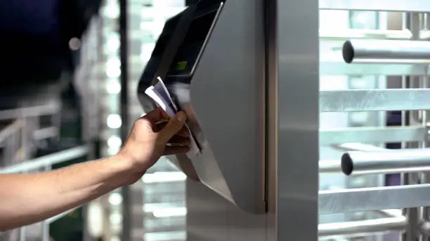 Man passing electronic turnstile, access control for business center, close-up