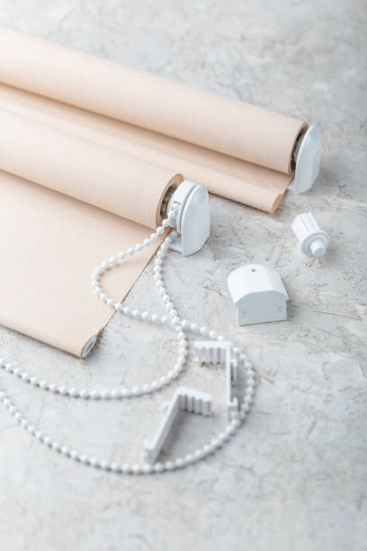 istock The roller blind lies on a white or gray concrete surface. 1124379425