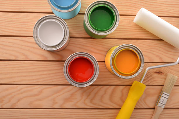 istock Colorful paint cans on wooden boards for work at home 1124381767