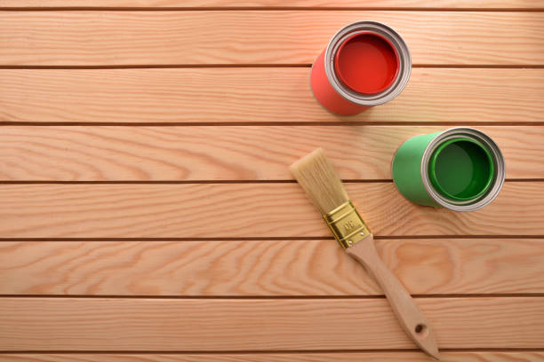 istock Two paint cans and brush on wooden slats top view 1124381823