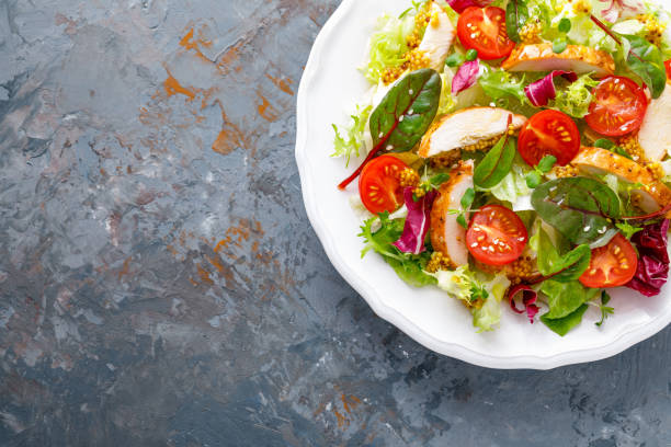 istock Fresh vegetable salad with grilled chicken meat, top view 1124382746