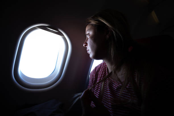 istock Blonde woman sitting in front of window on plane 1124384222