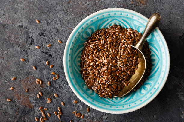 Flax seeds in bowl on dark background closeup top view Flax seeds in bowl on dark background closeup top view flax seed stock pictures, royalty-free photos & images