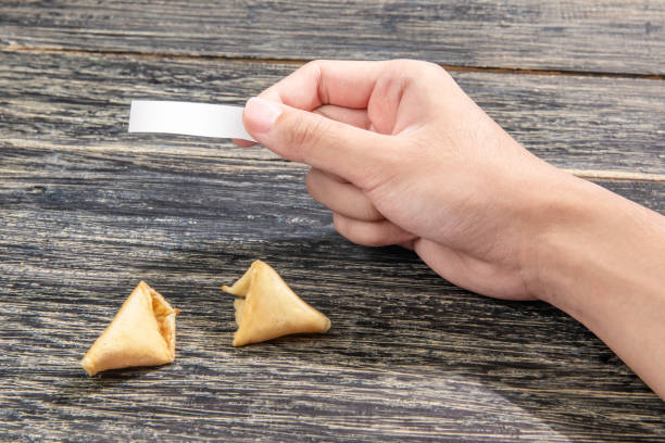 istock Human hand holding blank paper for quote or message from fortune cookies 1124388794