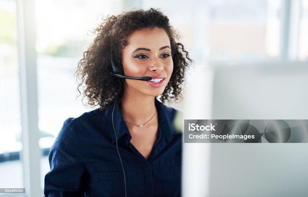She's determined to help as many customers as possible Cropped shot of an attractive young female call center agent working in her office Service Stock Photo