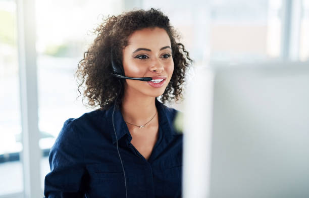 She's determined to help as many customers as possible Cropped shot of an attractive young female call center agent working in her office call center stock pictures, royalty-free photos & images