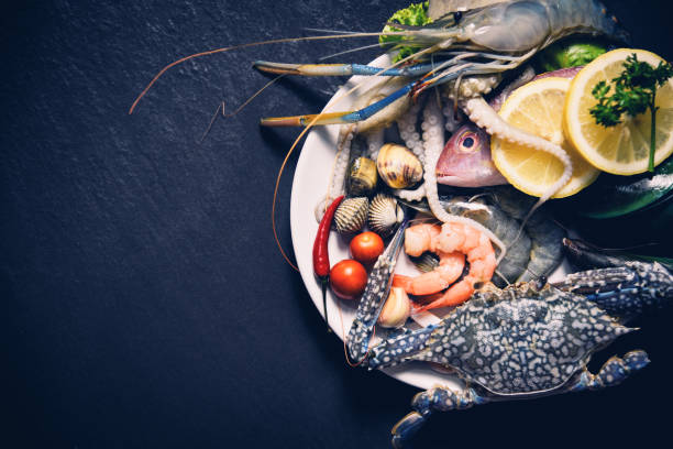 istock Shellfish seafood plate with shrimps prawns crab shell cockles mussel squid and fish ocean gourmet dinner 1124395437