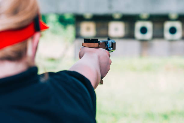 istock Close-Up Of Woman Aiming Gun 1124395975