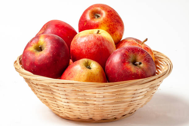 Dali apples in a basket on a white background Shooting at 100 mm macro, indoors, at 200 iso, f 20, 3/5 second yunnan province stock pictures, royalty-free photos & images