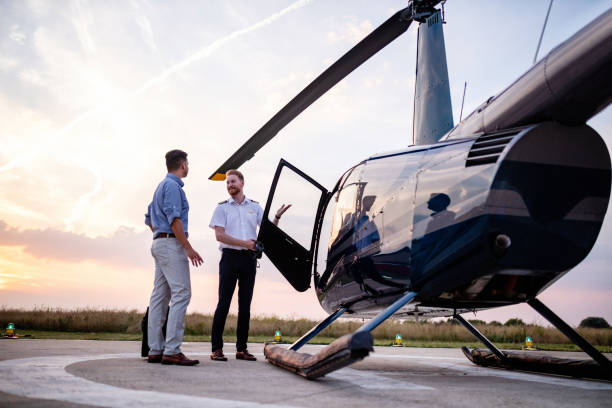 Chopper pilot greeting male passenger