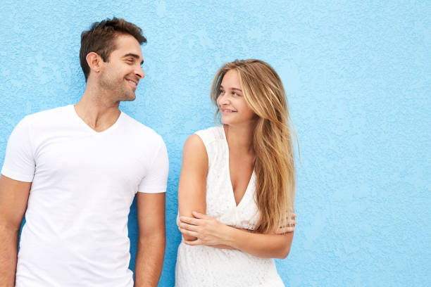 Smiling couple against blue