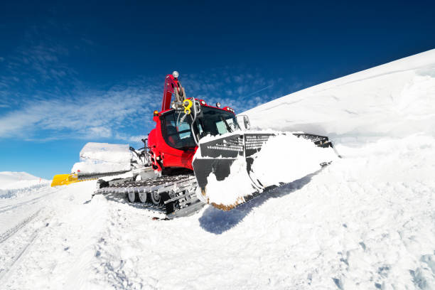 istock Snowcat clearing snow on a ski piste on a sunny day 1124400308