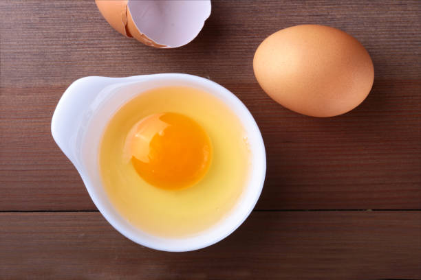 istock raw egg in white bowl ingredients for cooking. concept. Top view. 1124400407