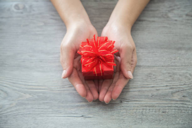 istock Valentine gift,Woman hand holding a gift box 1124400730