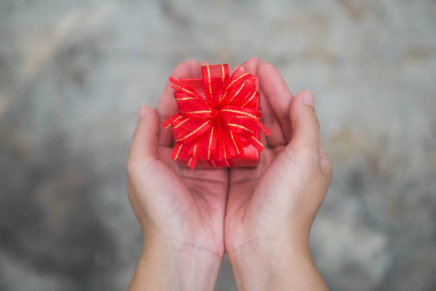 istock Valentine gift,Woman hand holding a gift box 1124400784