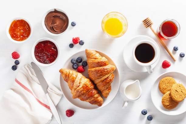 istock Continental breakfast with croissant, jam, chocolate spread and coffee. Top view 1124400835