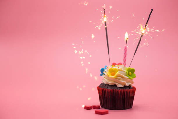 istock cupcake with sparkler on pink background 1124400877