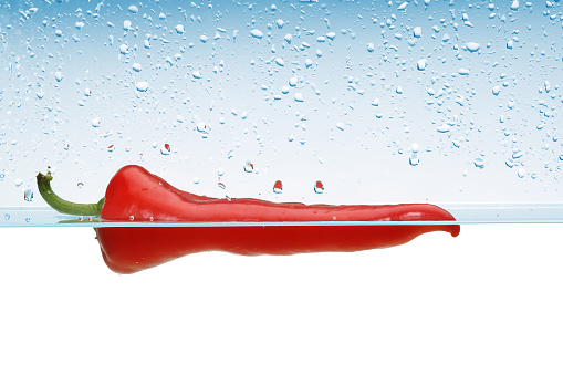Single Red pepper in water splash
