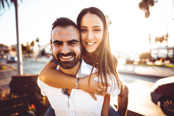 istock piggybacking couple at dusk on vacation 1124401229