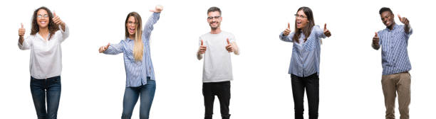 istock Group and team of young business people over isolated white background approving doing positive gesture with hand, thumbs up smiling and happy for success. Looking at the camera, winner gesture. 1124401346