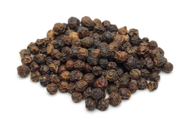 istock Heap of black peppercorn on white background 1124401535