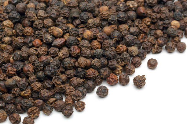 istock Heap of black peppercorn on white 1124402150
