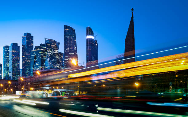 istock Modern office buildings with light trails of night traffic 1124403076