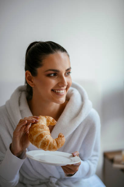 istock Woman having breakfast in bed 1124403395