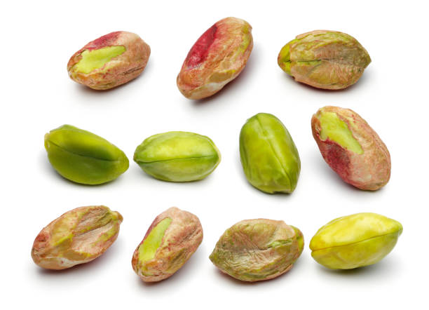 istock Peeled pistachio nuts on white background 1124404606