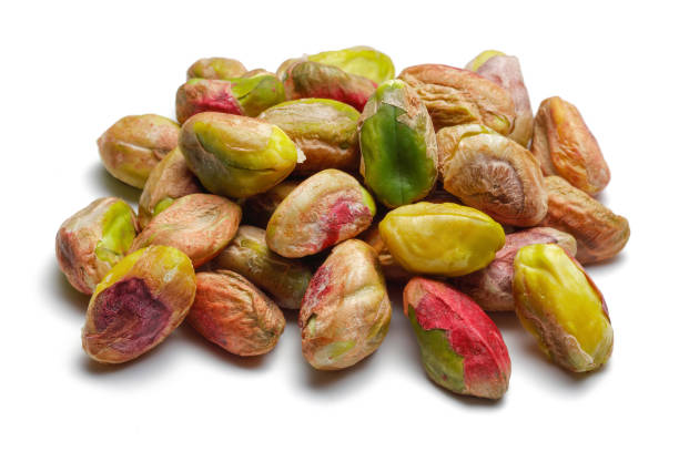 istock Peeled pistachio nuts on white background 1124404710