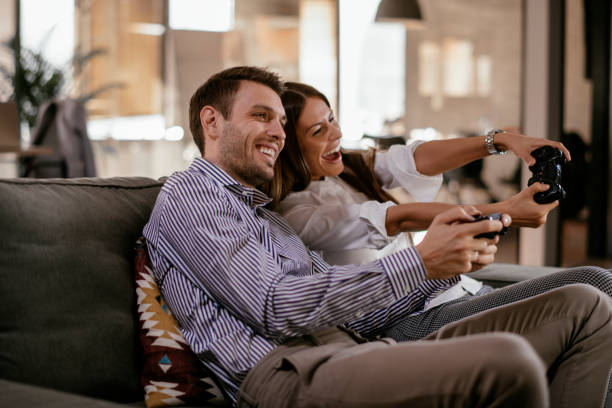 istock Happy couple playing video games 1124404954