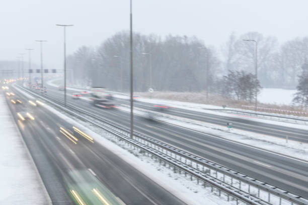 istock Moving traffic on a highway during a snow blizzard in winter 1124405062
