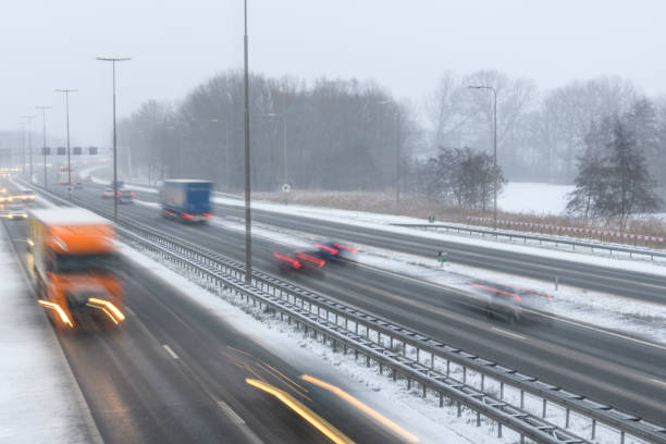istock Moving traffic on a highway during a snow blizzard in winter 1124405507