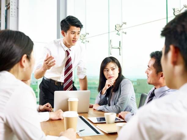 istock asian business man presenting ideas to group 1124405593