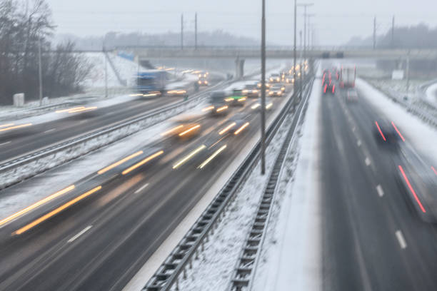 istock Moving traffic on a highway during a snow blizzard in winter 1124405808