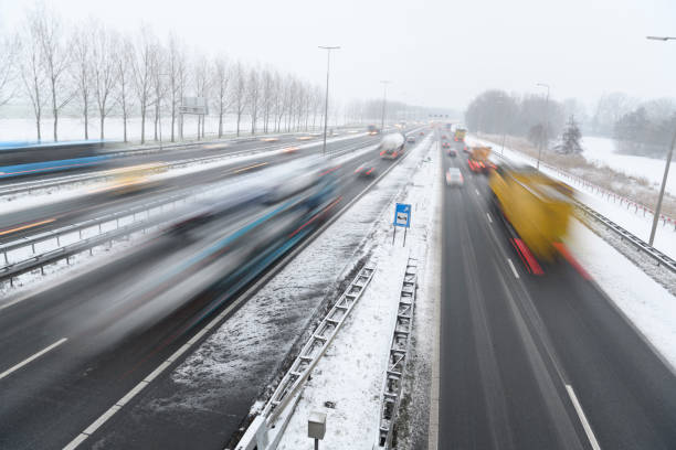 istock Moving traffic on a highway during a snow blizzard in winter 1124407242
