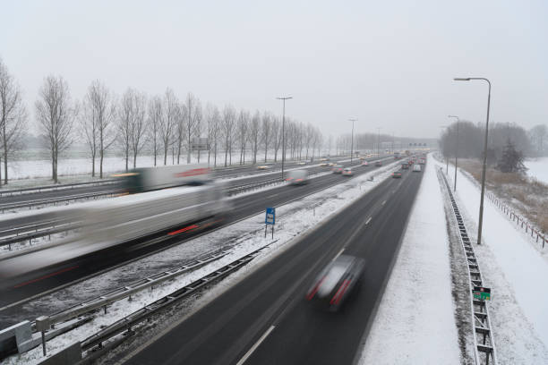istock Moving traffic on a highway during a snow blizzard in winter 1124407377