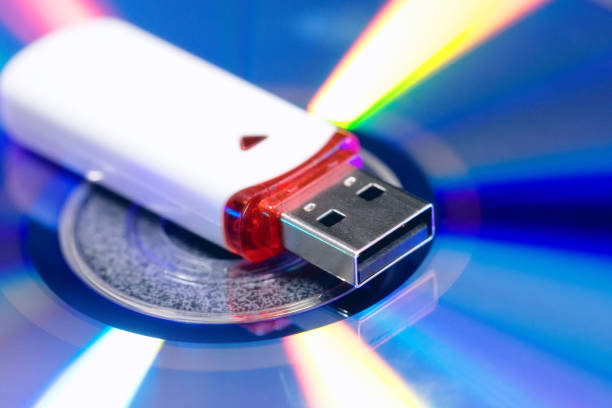 istock usb flash drive on cd disc background. new and old technology. equipment to store information. colored blue pink green and yellow gradients. concept of mobility and evolution technologies. 1124408018