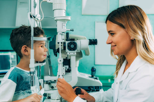 istock Smiling Ophthalmologist Doing Eye Test Of Boy 1124408045