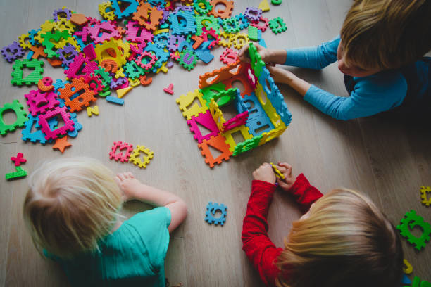 istock kids playing with number and shapes puzzle 1124410187
